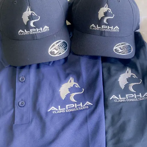 Custom embroidered navy hats and polos with Alpha Claims Consultants logo by Miami Epic Tees
