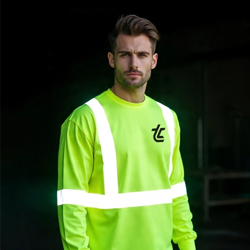 Man wearing neon safety long sleeve shirt with reflective stripes and custom printed logo, dark background.