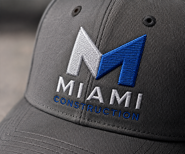 Custom embroidered Miami Construction logo on a black baseball cap