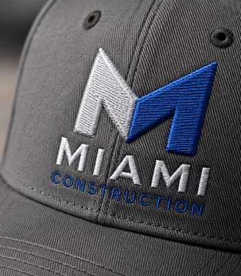 Custom embroidered Miami Construction logo on a black baseball cap